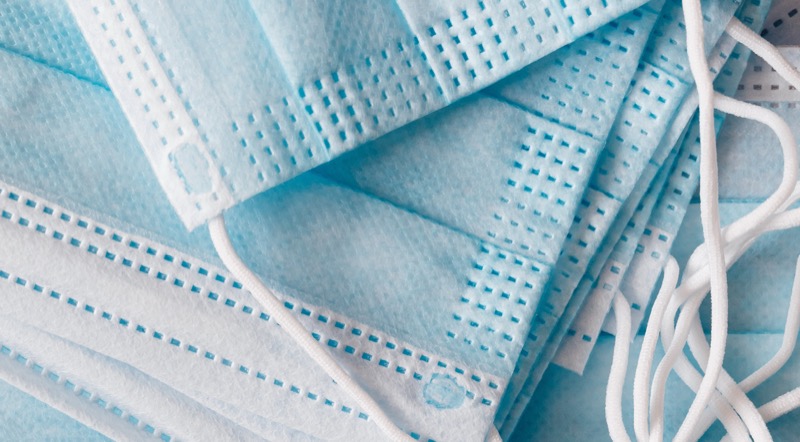 Blue surgical masks laid flat